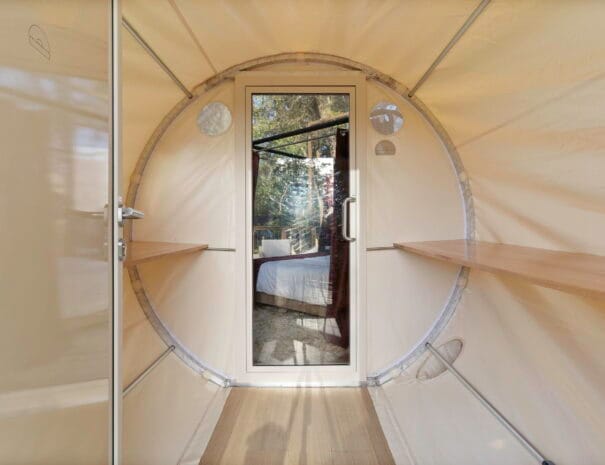 Step through the airlock-style entrance of your bubble dome—a unique feature that maintains climate control and enhances the immersive glamping experience.