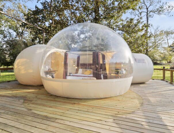 Our fully transparent glamping domes let you reconnect with nature without sacrificing comfort. Set on private wooden decks and surrounded by greenery, these domes offer one-of-a-kind views by day and night