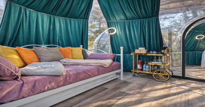 Luxury camping dome with bed and decor inside