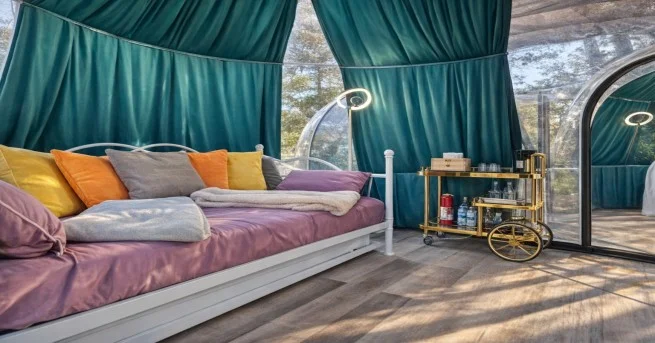 Luxury camping dome with bed and decor inside